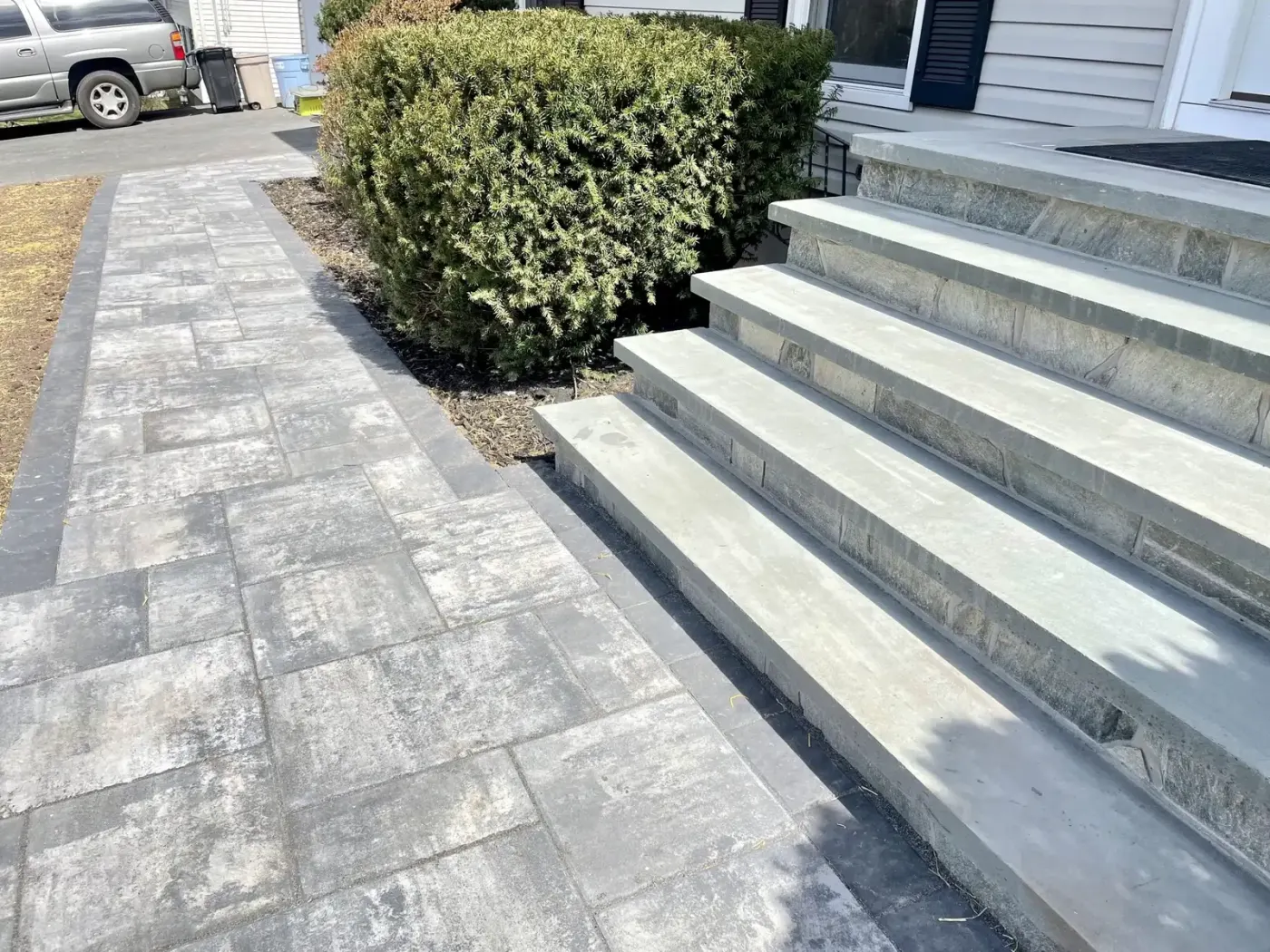 Stone front steps connected to a paver walkway