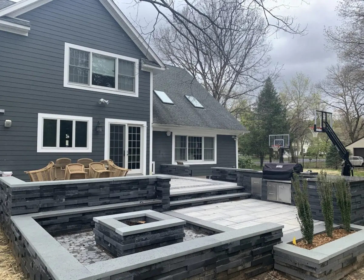 Fire pit with masonry seat walls and outdoor kitchen