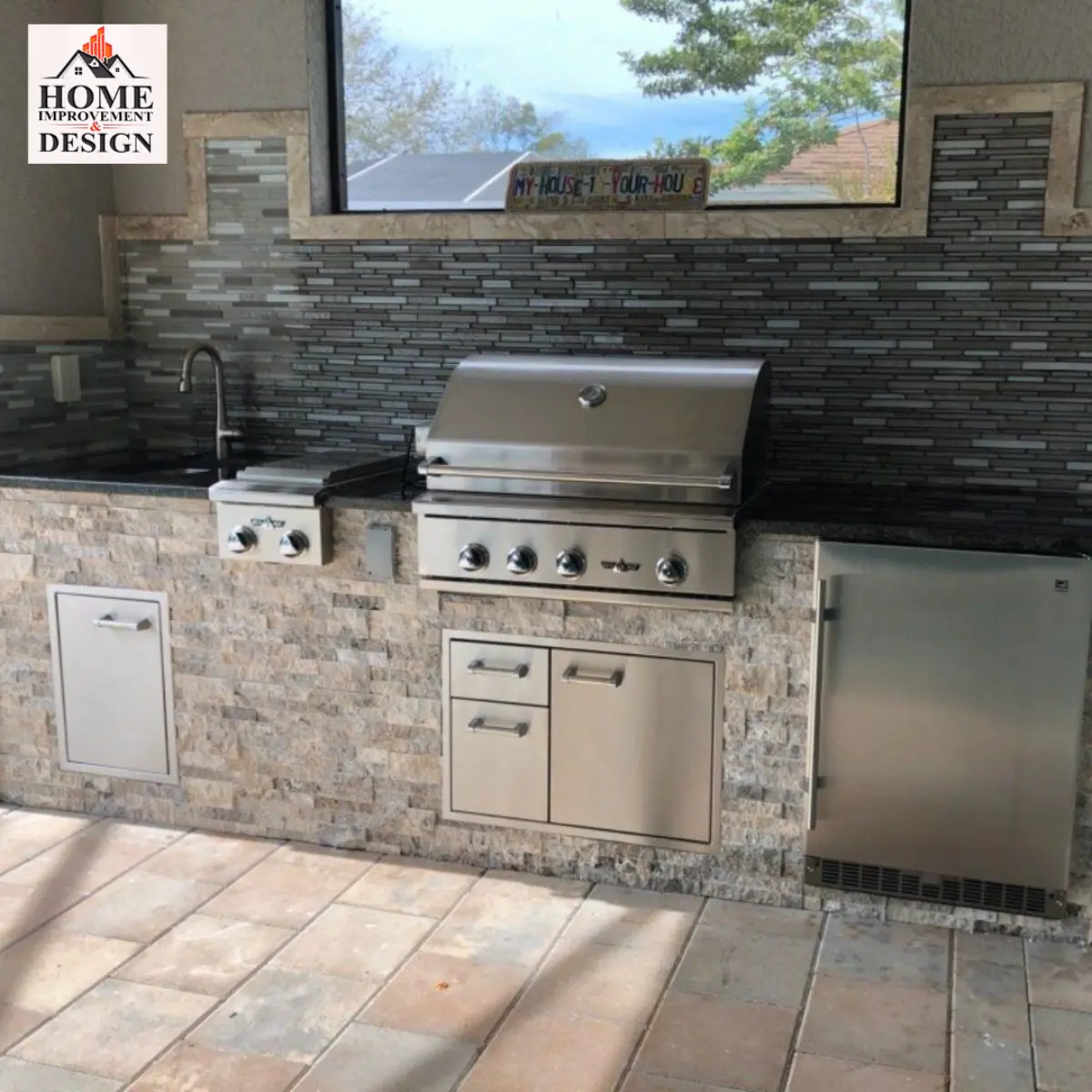 Stone outdoor kitchen island with a built-in grill