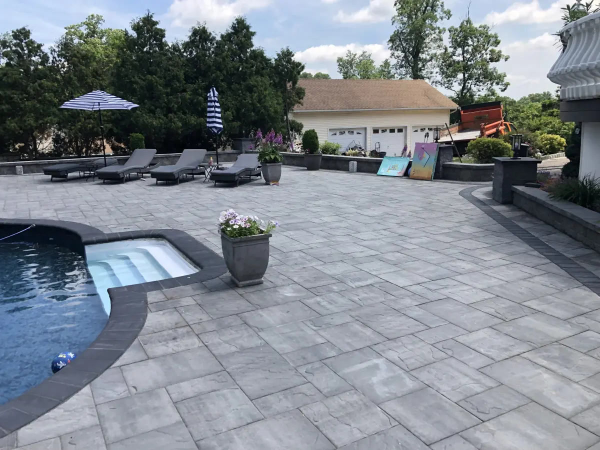 Backyard pool with a broad paver deck