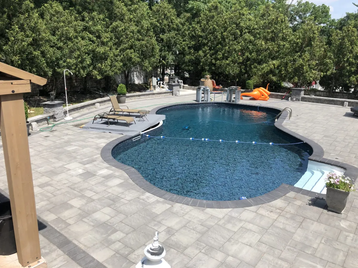 Paver patio wrapping around a residential pool