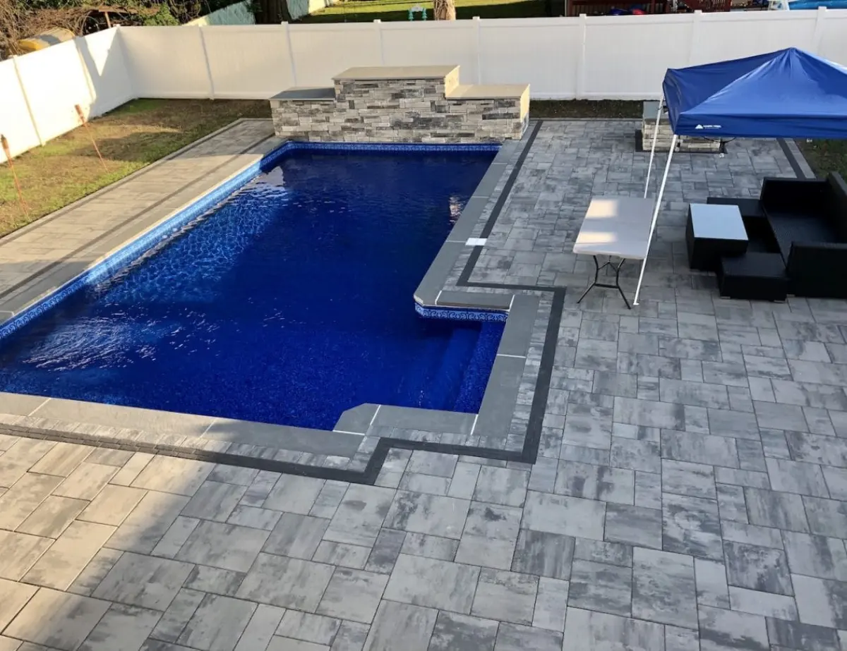 Pool patio with gray pavers and contrasting border