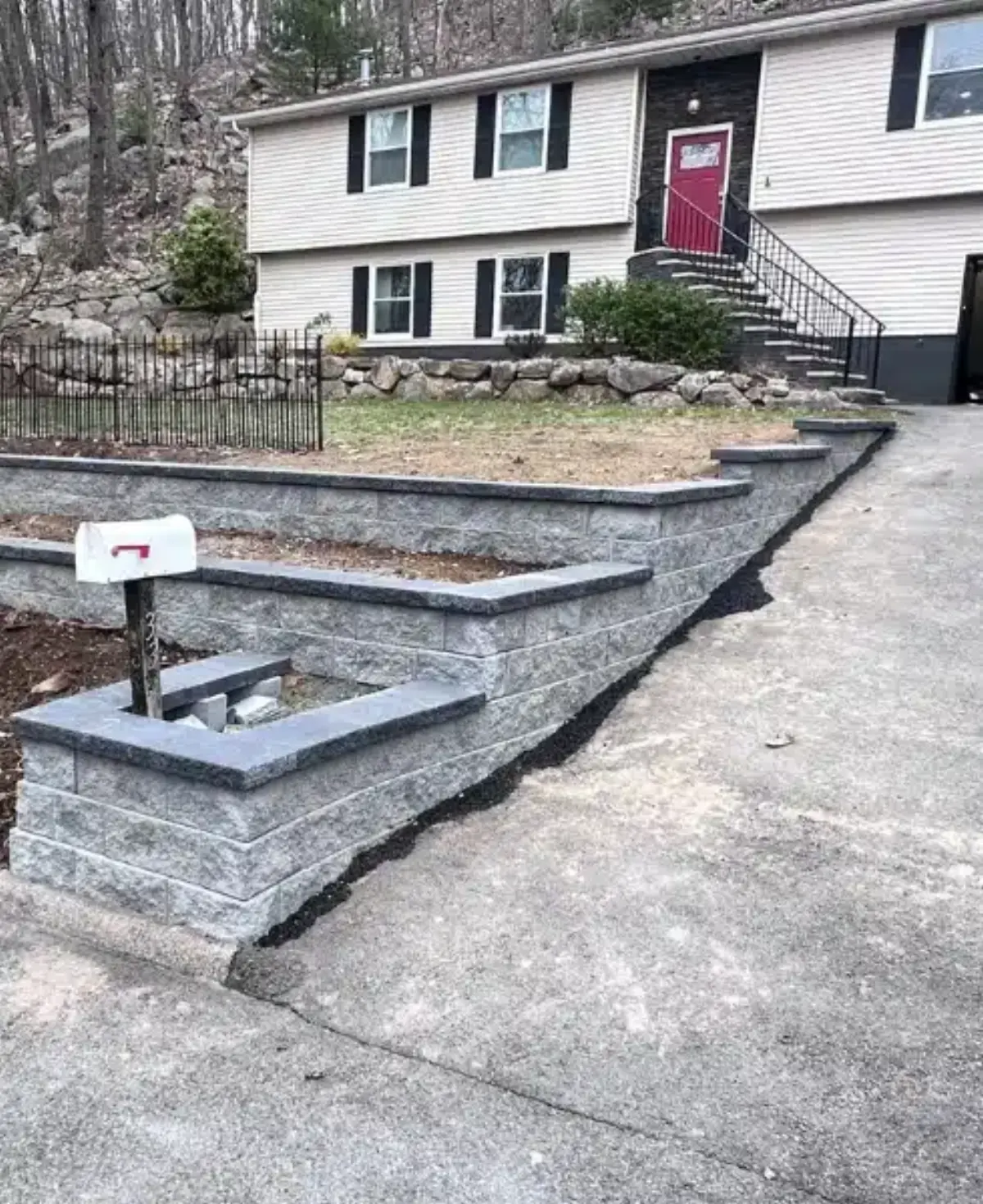 Rebuilt retaining wall beside a residential driveway
