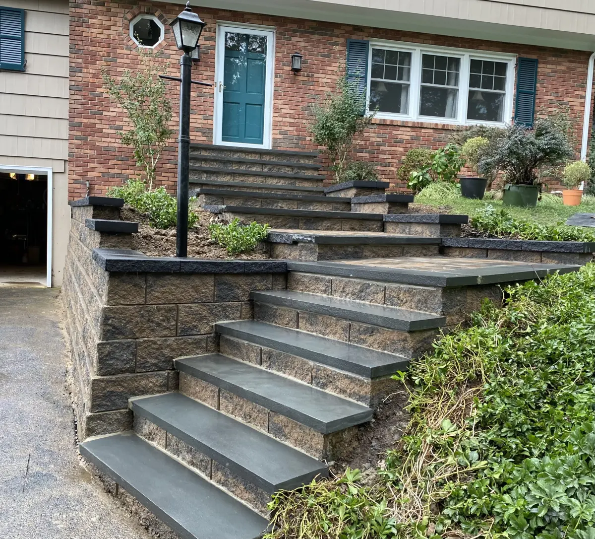 Broad stone front steps with white railings