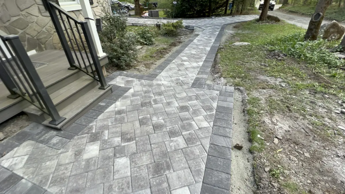 Completed curved paver walkway leading to a porch