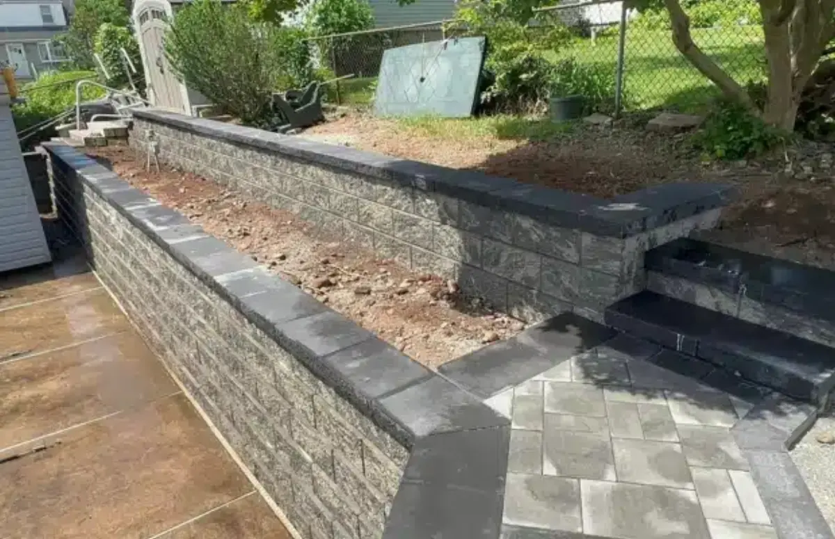 Two tiers of block retaining walls with a stair connection