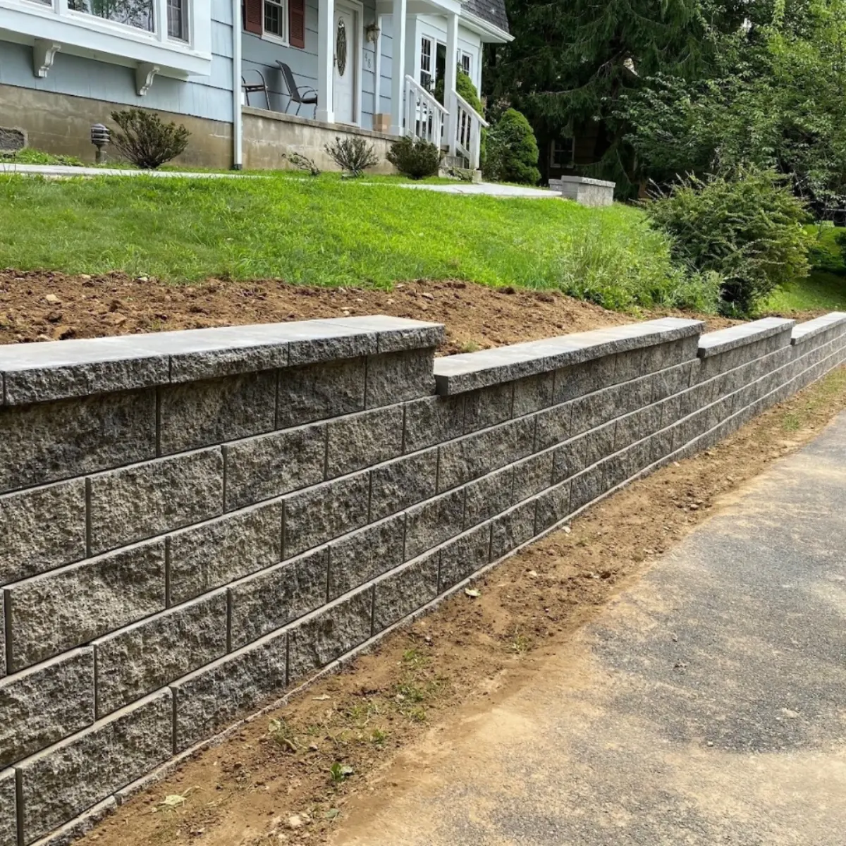 Finished block retaining wall along a sloped front yard