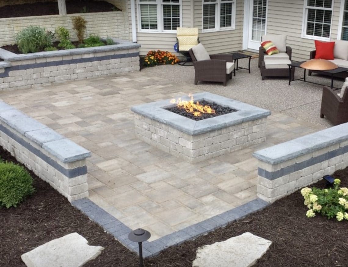 Paver patio with a central fire pit and built-in seating